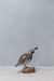 painted quail on wood stump