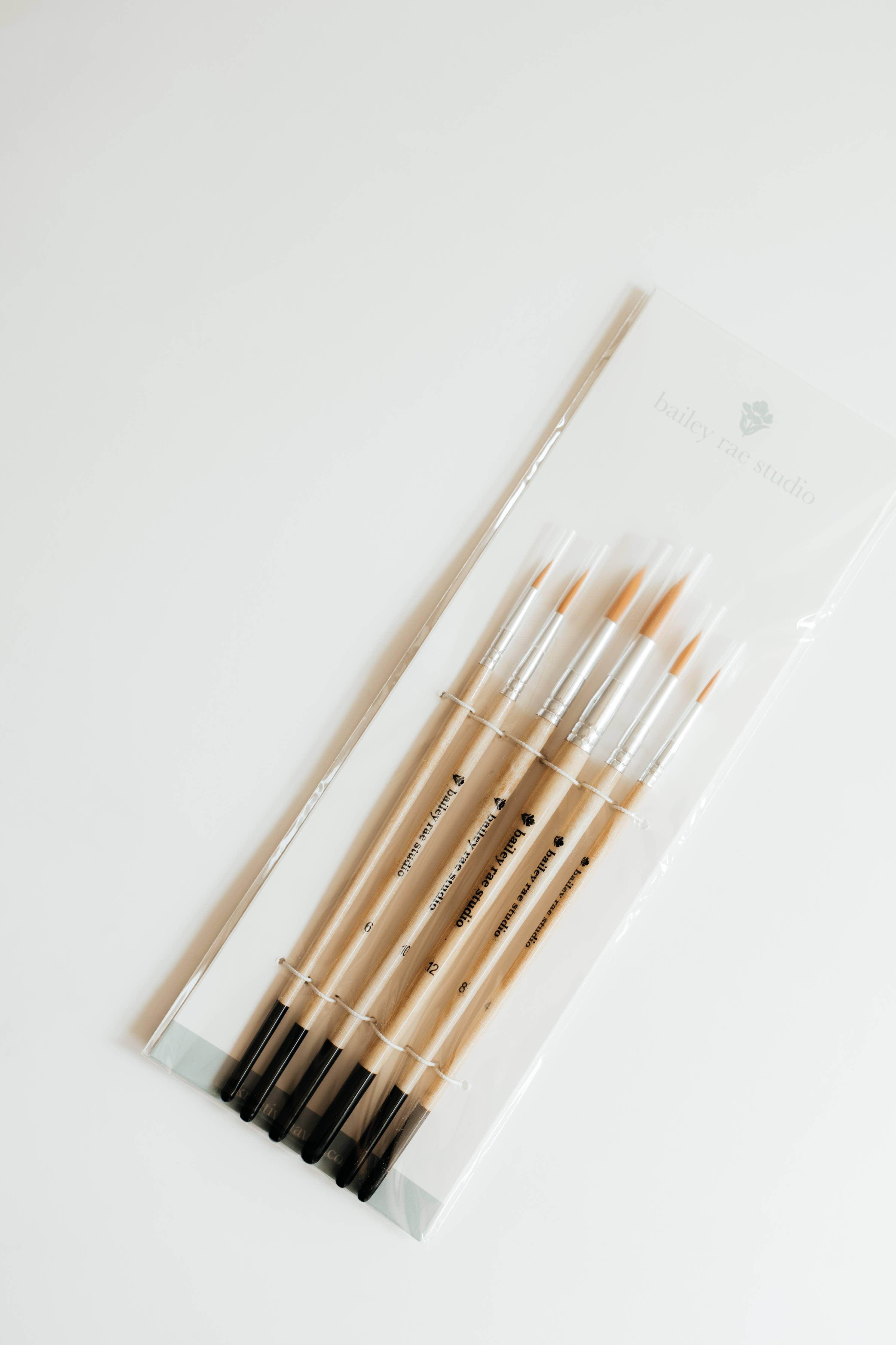 Round Tip Watercolor Brush Set displayed with vibrant watercolors, demonstrating versatility for different painting techniques.