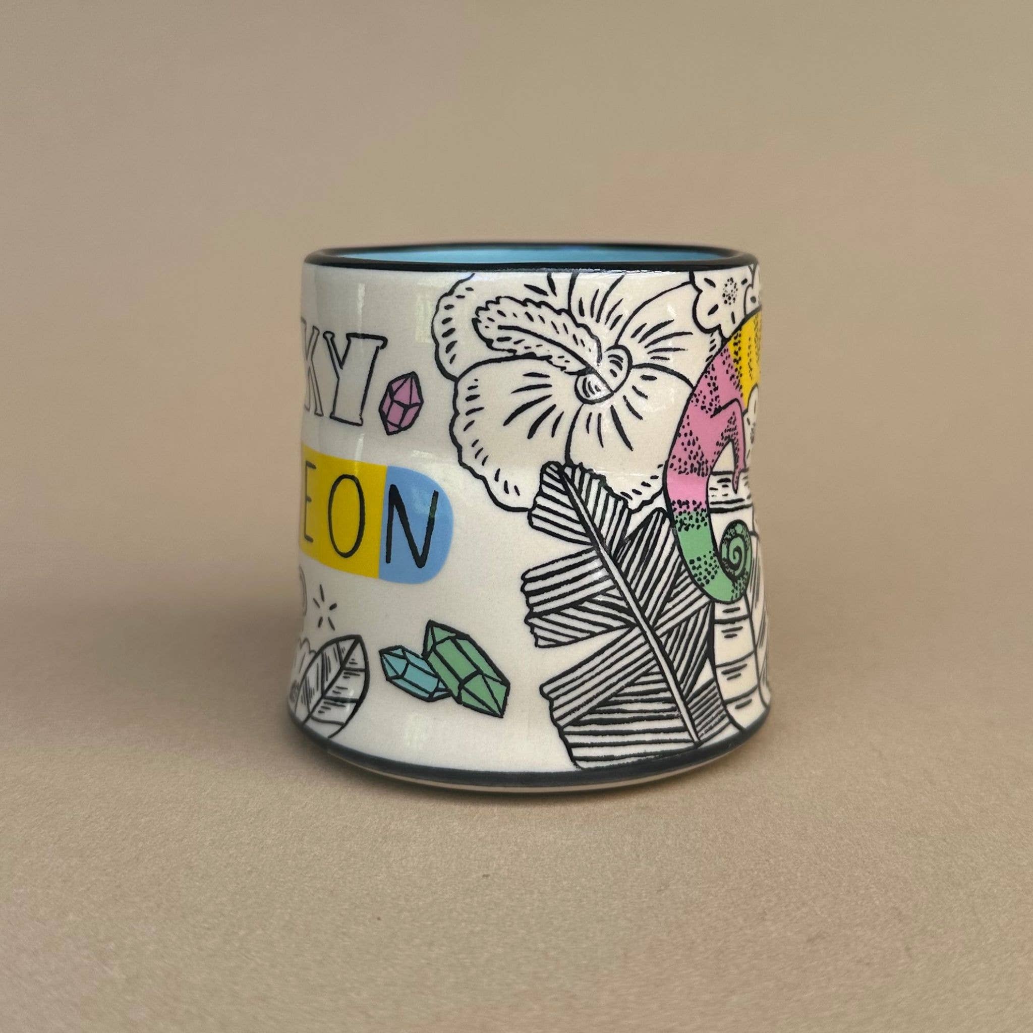 Lucky Chameleon Cup - Medium by The Bowl Maker presents a whimsical design with chameleon and floral motifs, adding a colorful touch to your drinkware.