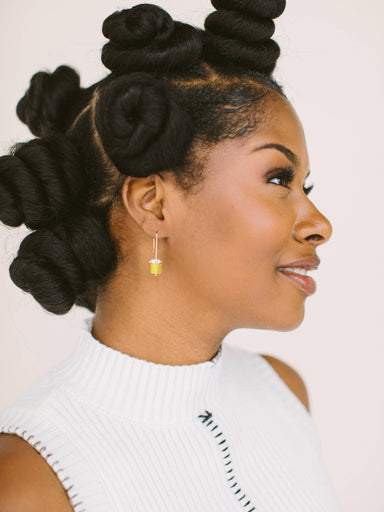 woman wearing porcelain cylinders dangle earrings