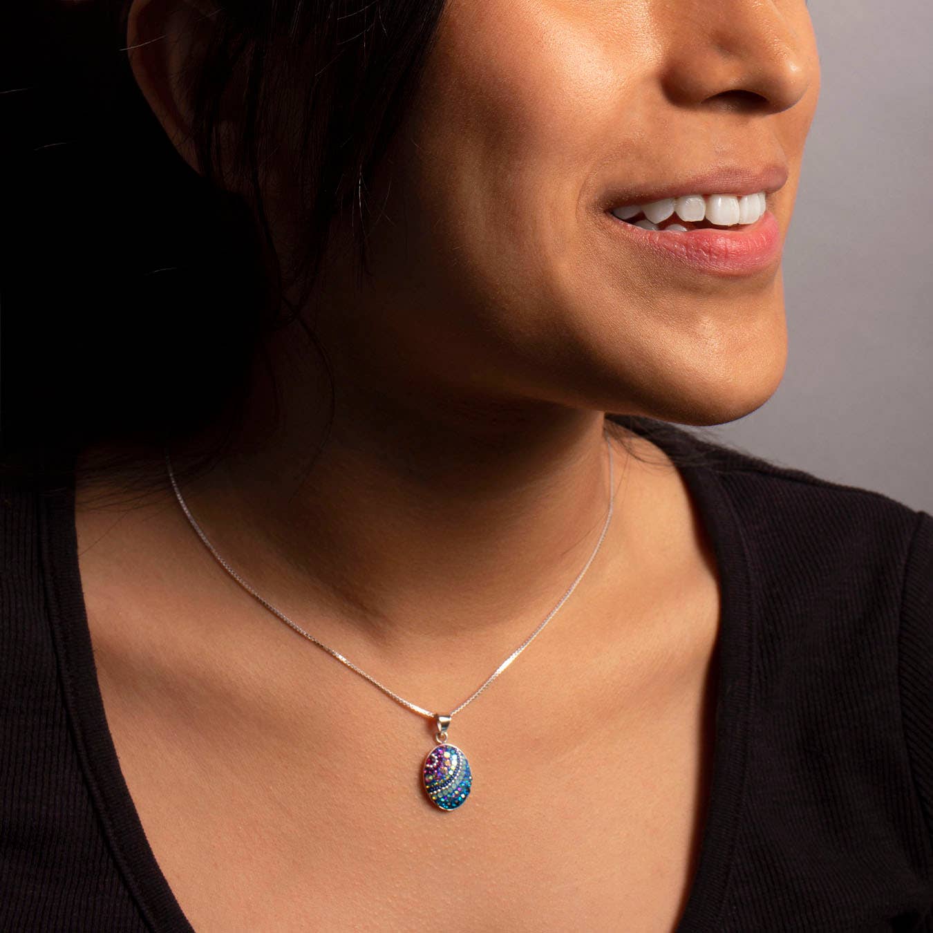 Close-up view of the Mosaico Jewels Petite Oval Pendant in Crystal & Silver highlighting exquisite craftsmanship and design.