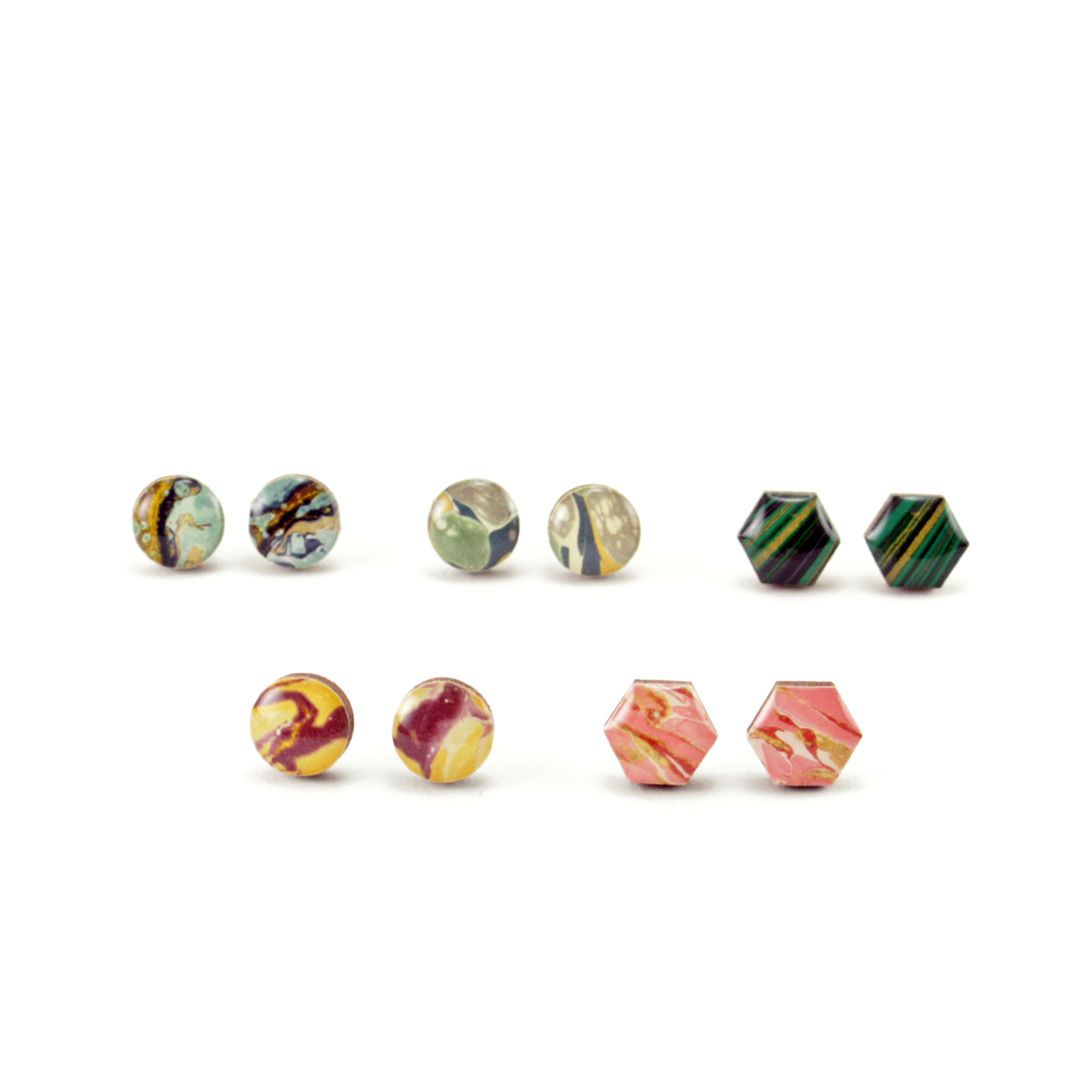 Close-up of patterned mini titanium stud earrings featuring vibrant floral Chiyogami and unique textures.