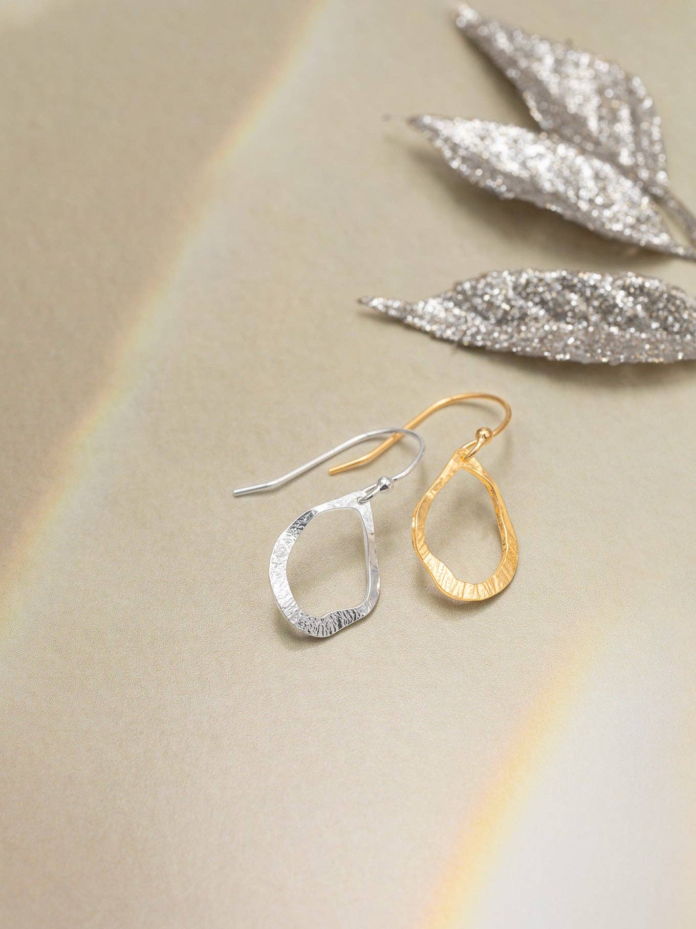 Nina Earrings styled on a model - wearing gold hoops so iconic, they might just start their own fan club.