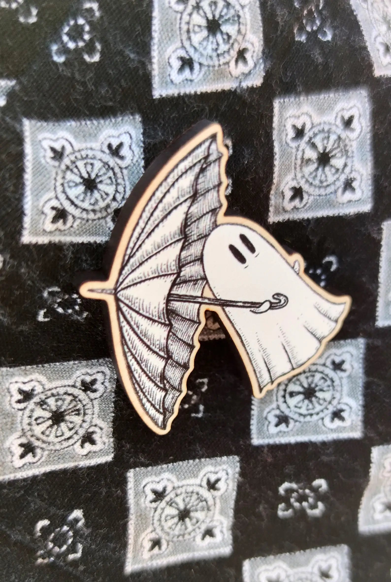 wood ghost pin carrying an umbrella