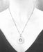 Alternate view of Brass Short Cored River Stone Stack by Suzanna Garrett Designs — this pendant turns a river stone into a tiny frame for an even tinier pebble stack