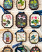 Handmade folk bird art locket ornaments with vintage collage print in an antiqued glass frame.