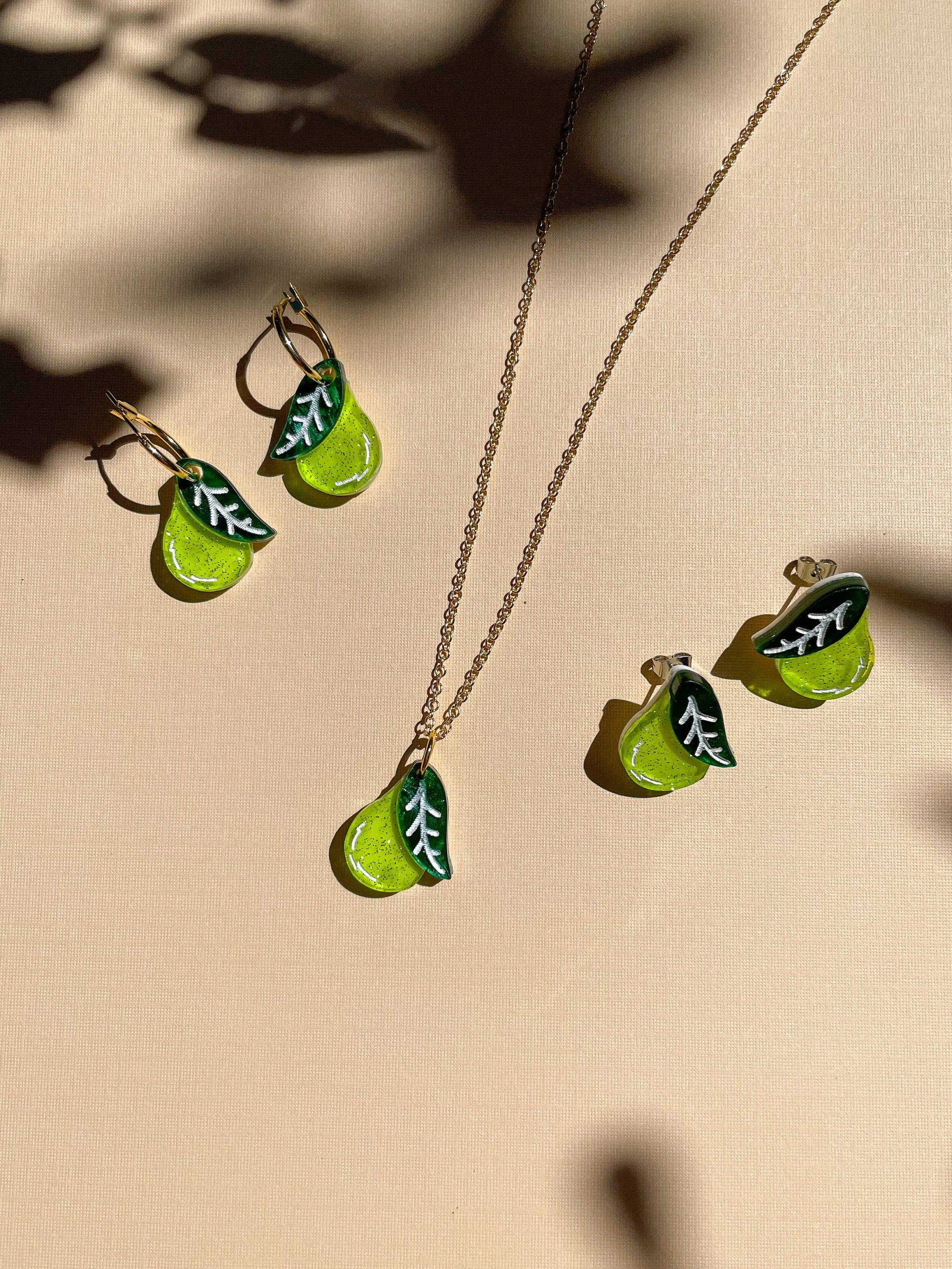 Mini Pear Dangle earrings and necklace set by Sunnie Creative on a light background, highlighting the vibrant green pear shapes with leaf accents.
