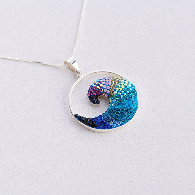 Free Wave Pendant by Mosaico Jewels showcasing a crystal and silver design inspired by ocean waves, symbolizing strength and beauty.