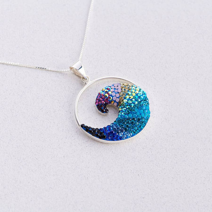 Free Wave Pendant by Mosaico Jewels showcasing a crystal and silver design inspired by ocean waves, symbolizing strength and beauty.