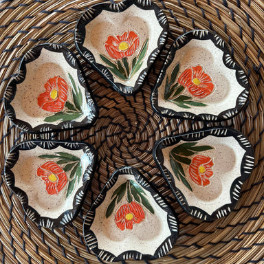 Five Floral Sgraffito Heart Trinket Dishes arranged in a circle, featuring vibrant orange flowers and green leaves, made by Tough Kitty Designs.