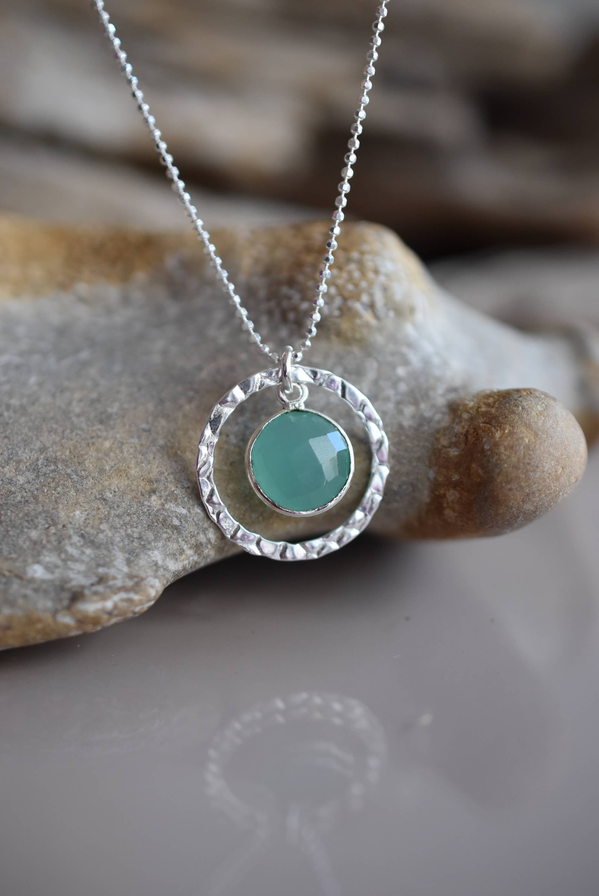 Sterling Silver Aqua Chalcedony Necklace by Whitelotus Design, featuring a hand-textured circular bezel surrounding a soft translucent aqua chalcedony gemstone, perfect for everyday wear.