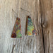Close-up of Triangle Dangle Earrings Flower displaying unique fire-painted copper design and stainless steel earwires.