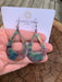 Boho Large Open Teardrop Fire Painted Copper Earrings hanging elegantly, showcasing vibrant colors and unique patterns.