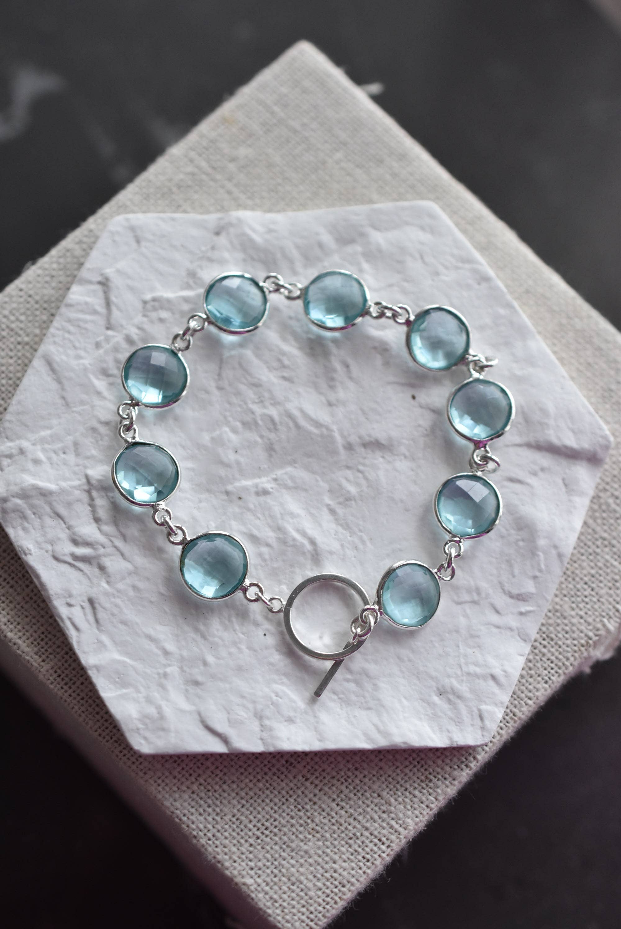 Handmade sterling silver sky blue topaz bracelet featuring a classic linked design by Whitelotus Design, showcasing luminous faceted gemstones.