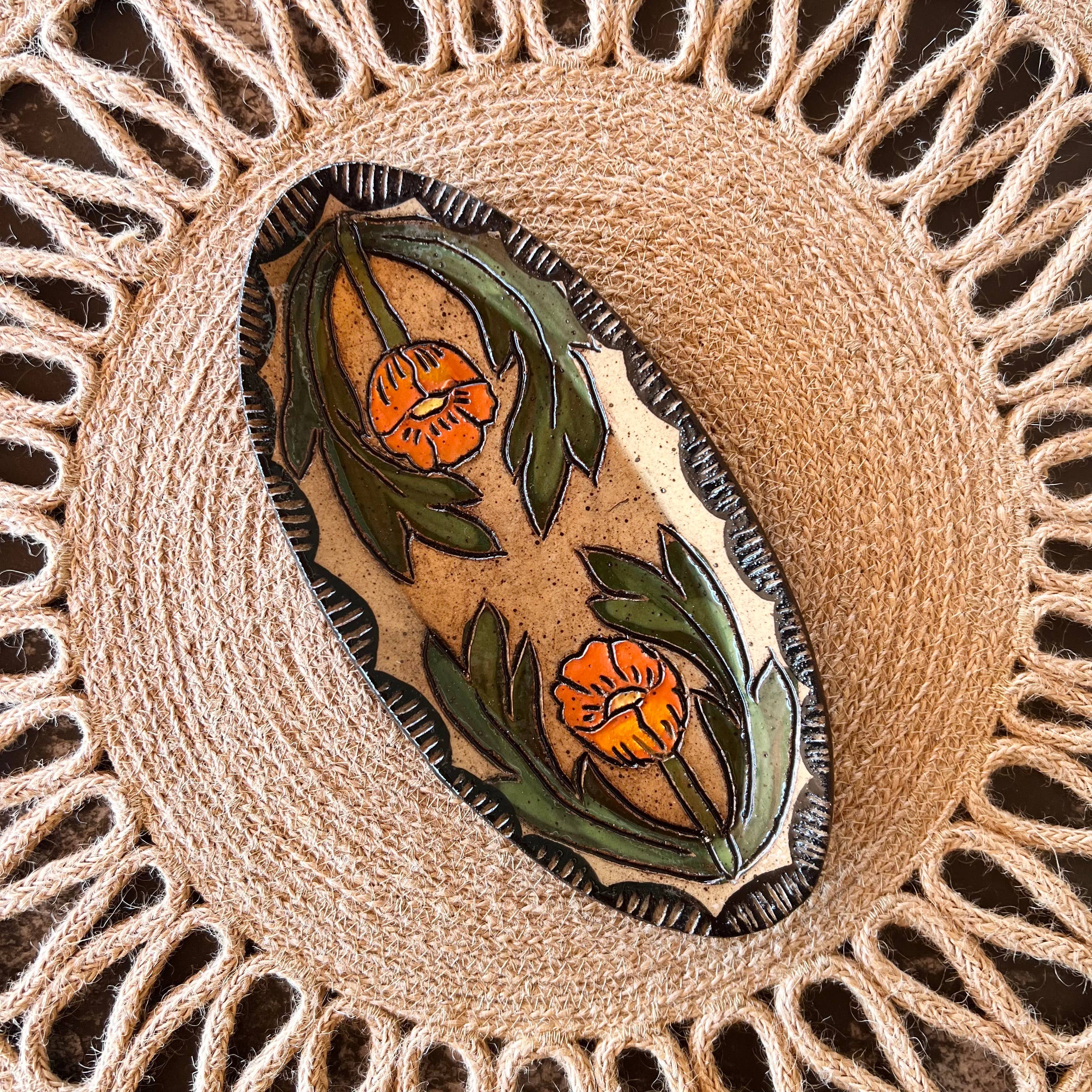 Globe Mallow Sgraffito Trinket Dish by Tough Kitty Designs, handmade with unique floral design on buff clay, showcasing the intricate carving and vibrant colors, approximately 7 inches by 4 inches.