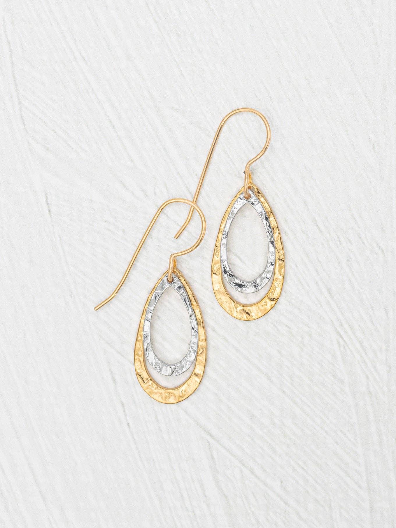 Shimmering Halo Drop Earrings by Holly Yashi, featuring hand-hammered gold and silver teardrops—perfect for when you want to shine brighter than your personality!