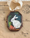 Vintage-style rabbit art locket ornament.