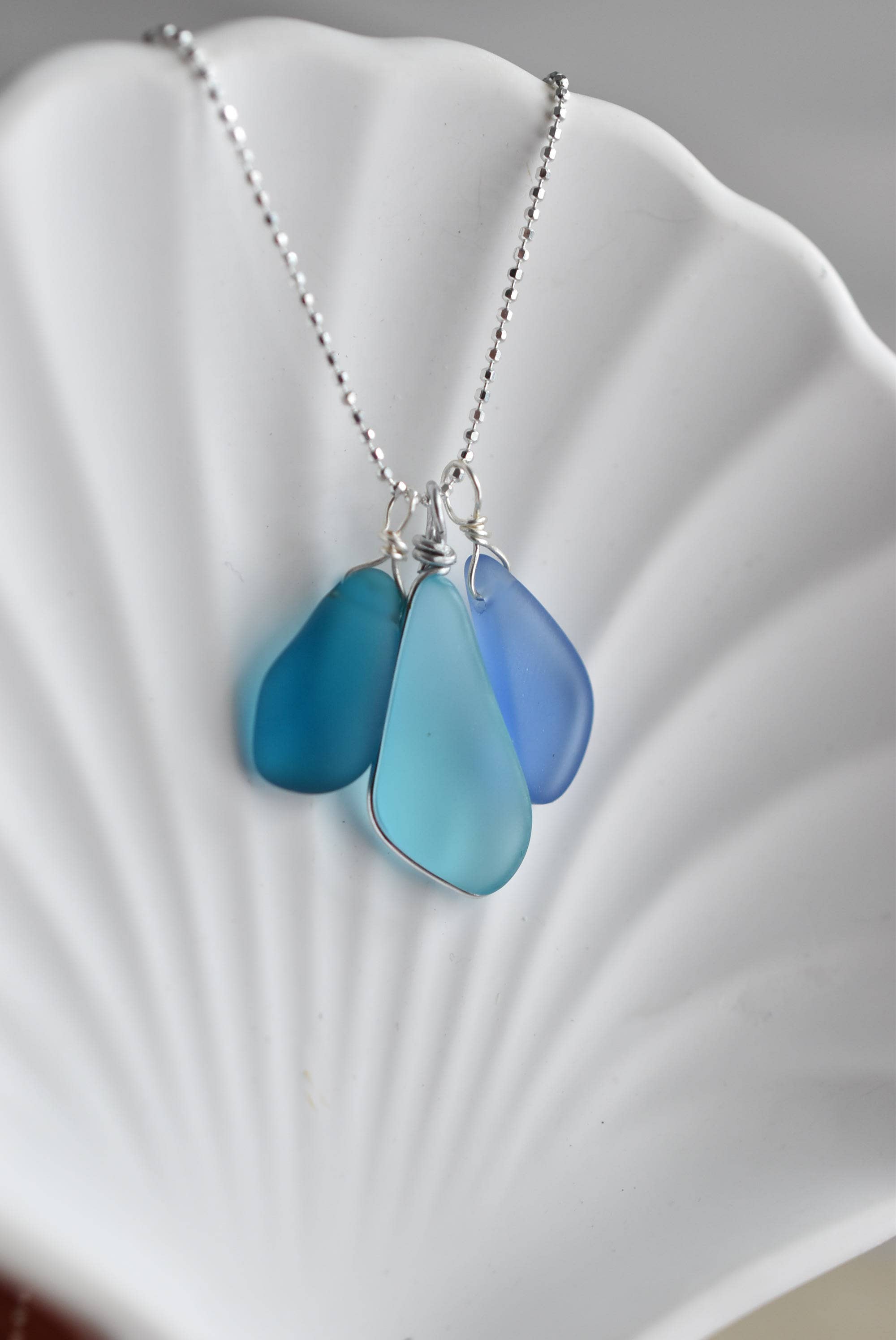 Blue Eco Glass Trio Sterling Silver Necklace showcasing three eco-friendly recycled glass drops in ocean blue colors, perfect for ocean lovers.