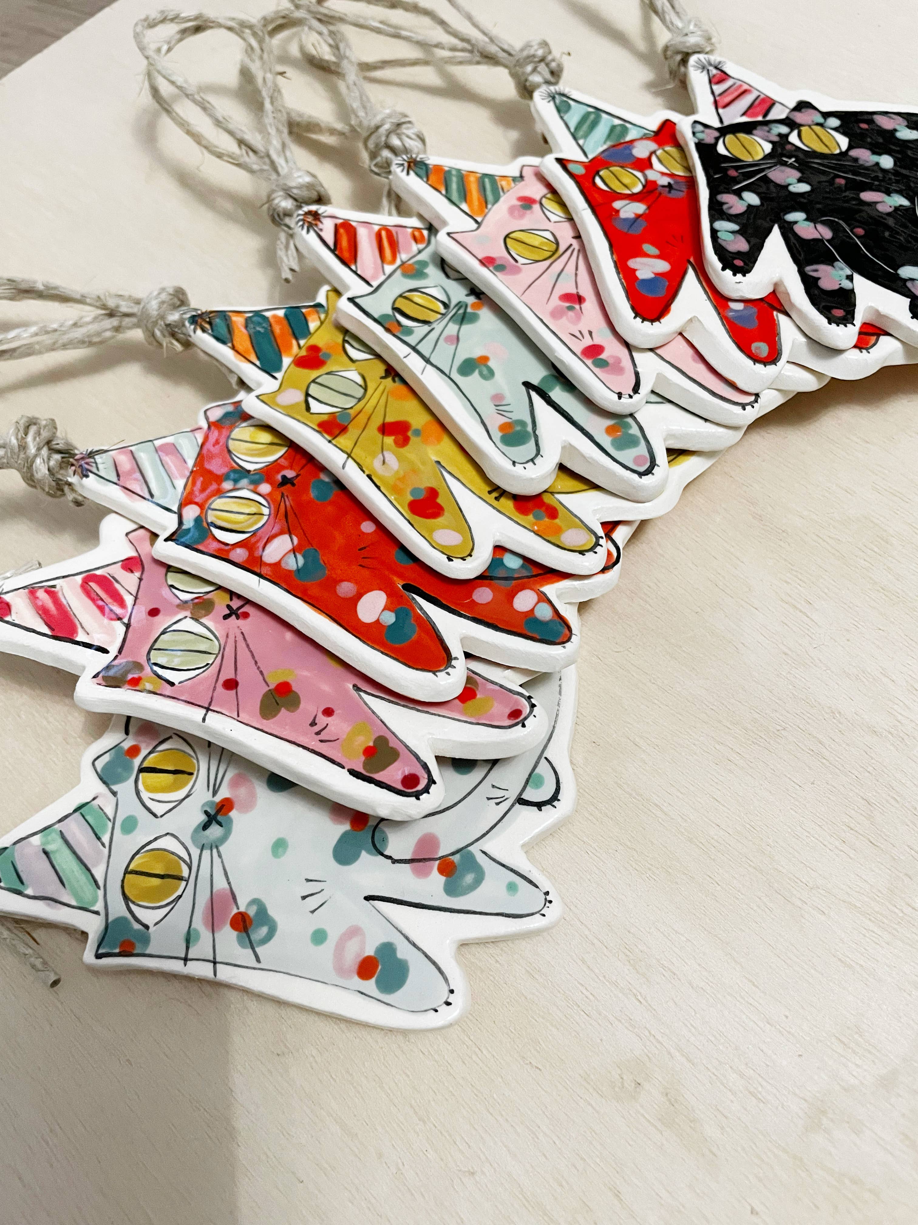 Group of Party Cat Ornaments with Colorful Party Hats in various colors, highlighting their playful designs and versatility for festive decor.