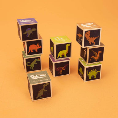 Uncle Goose Dinosaur Blocks set showing colorful and friendly dinosaur illustrations, including T-Rex, Triceratops, and Pterodactyl, designed to inspire little paleontologists with fun textures and educational info, perfect for ages 2 and up!