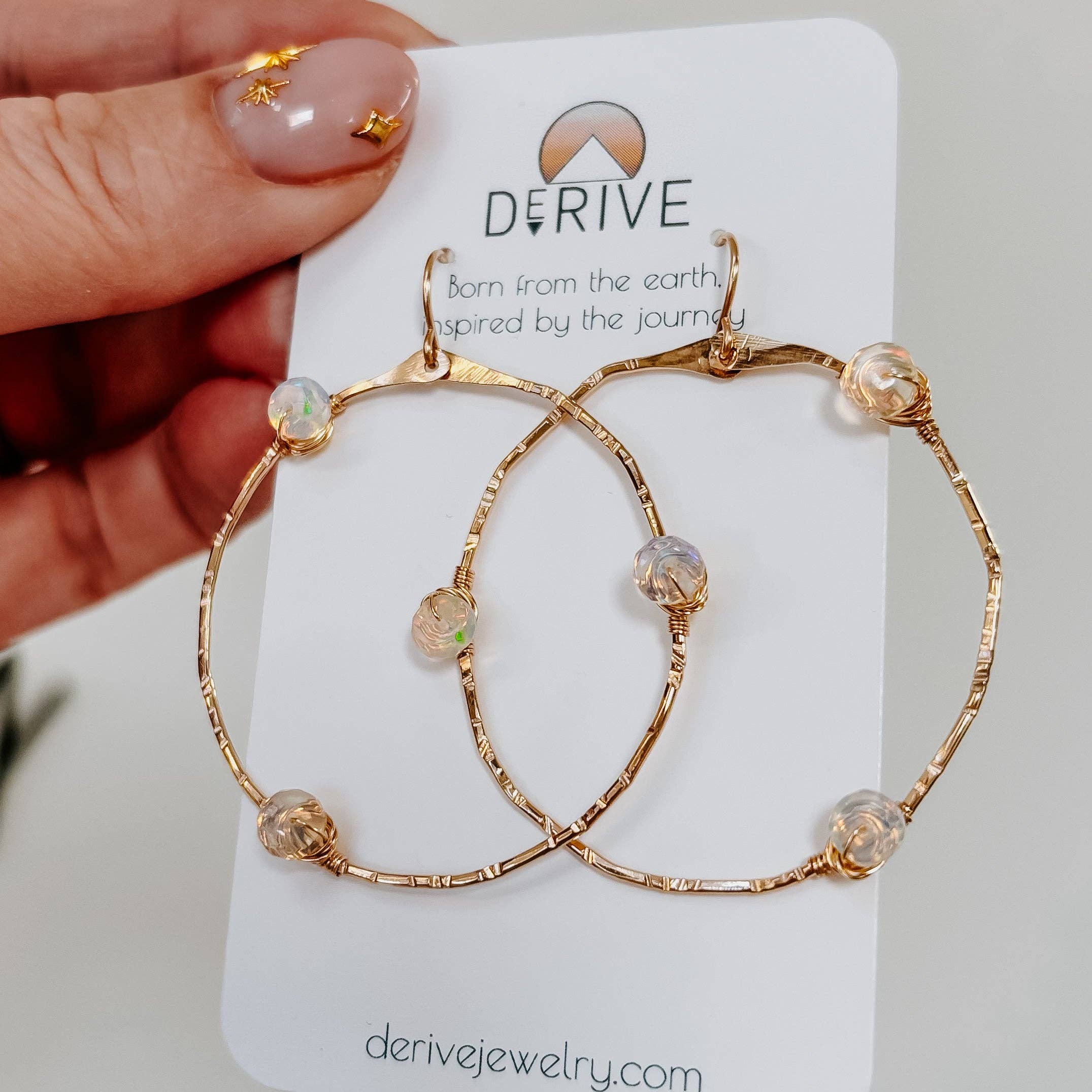 Stargazer Opal Hoop Earrings: These 1.5" hoops offer a texture that’s smoother than your best pickup line, available in 14k gold fill or sterling silver, and guaranteed to be hypoallergenic, because who needs a rash on date night?