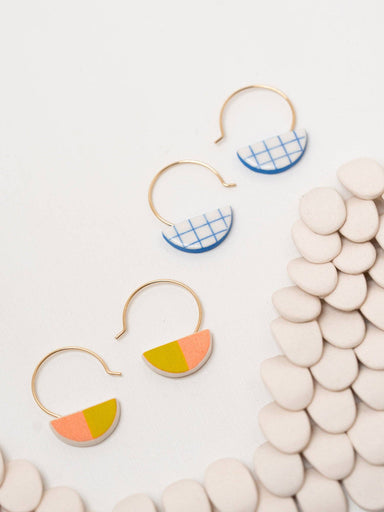 Little Slice Hoops by Twenty Two West – Adorable half-moon earrings in colorful porcelain, cradled by shiny gold-fill or sterling silver hoops, perfect for adding a touch of glam to any outfit and snacking on style!