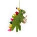 Colorful dinosaur ornament holding a birthday cupcake with a candle