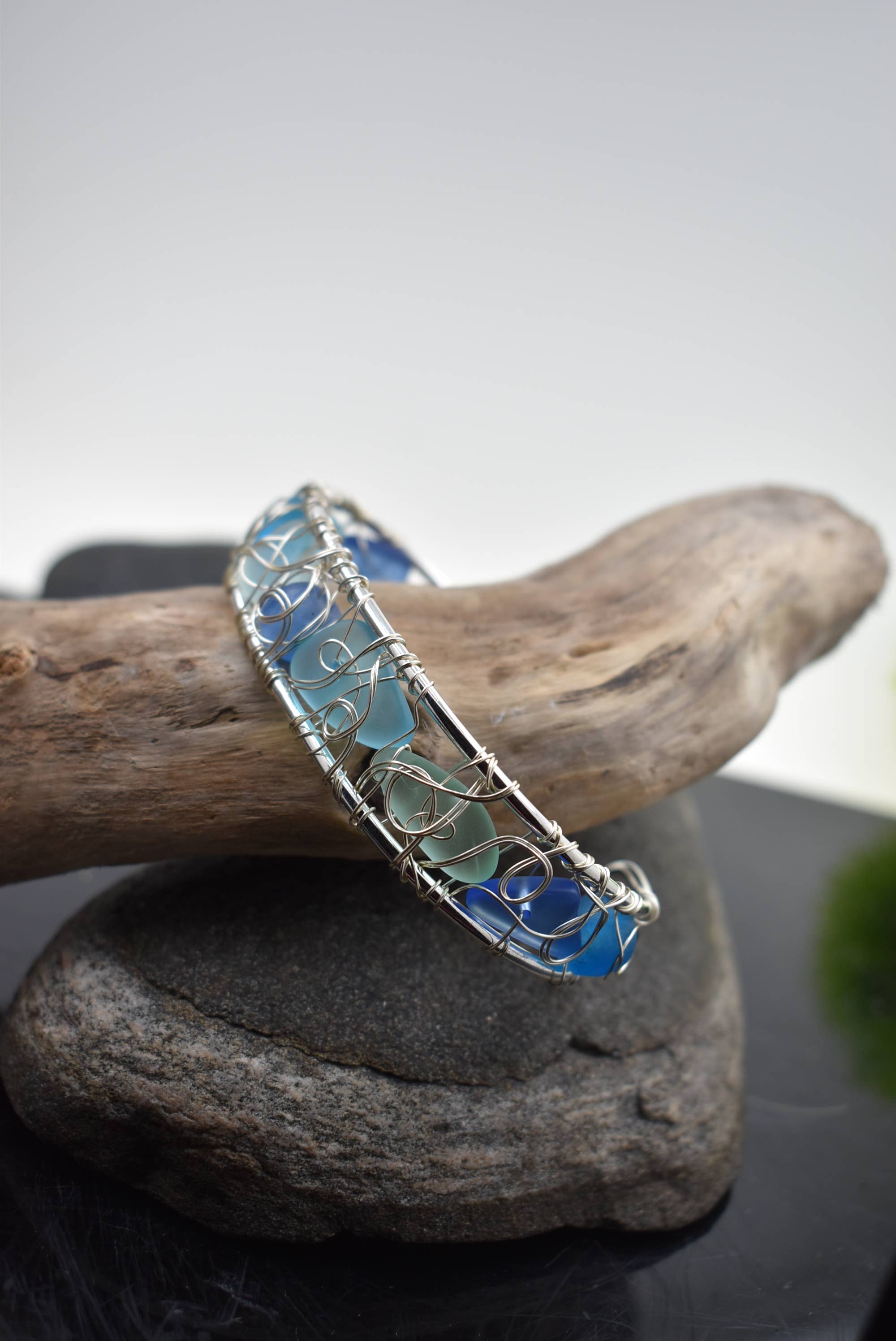 Stylish display of the modern wire woven eco glass cuff bracelet, emphasizing its open cuff design and coastal-inspired textures, ideal for boutique jewelry collections.