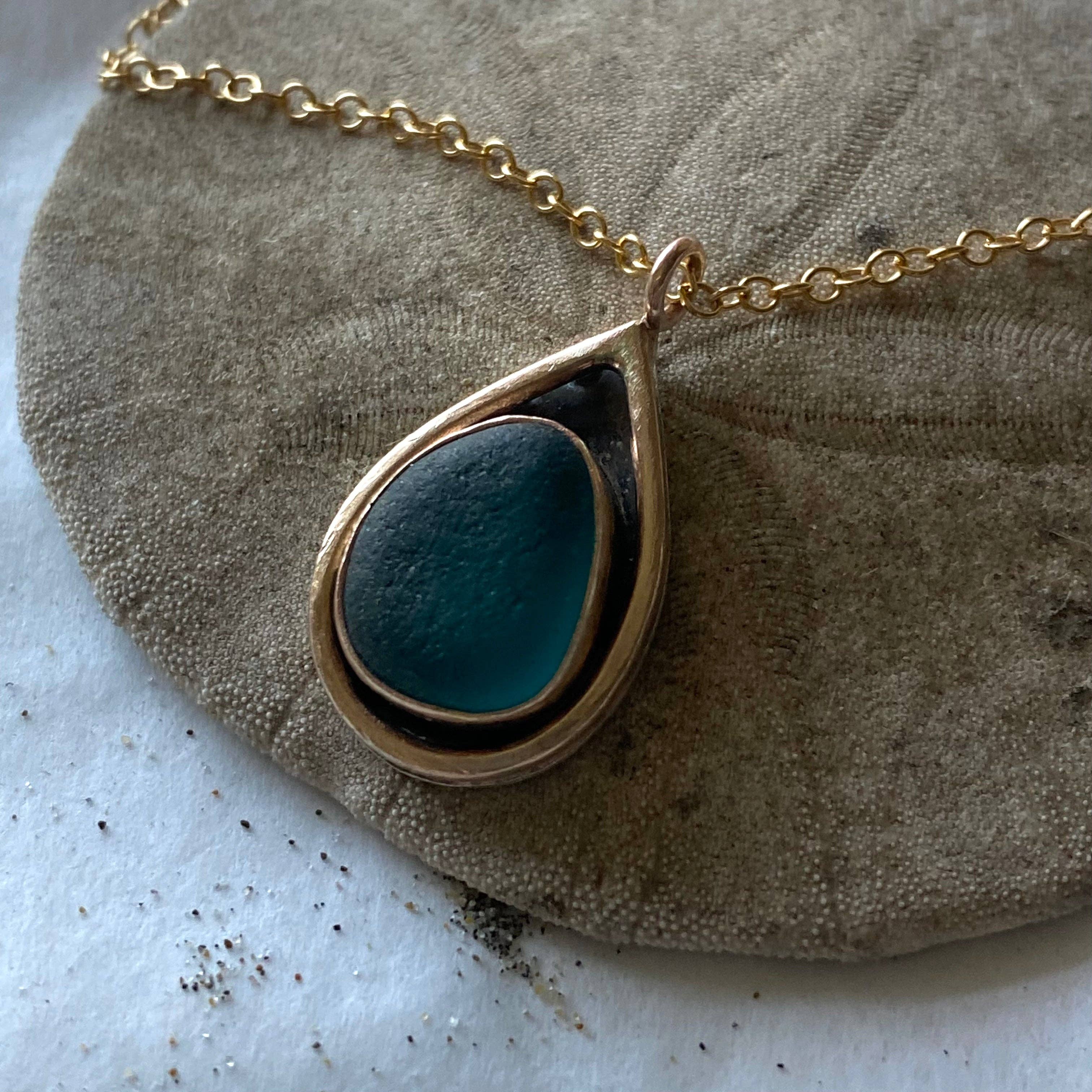 Mermaid Tear Necklace worn by a model, embodying the coastal charm of California with this unique sea glass jewelry.