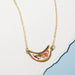 Moon Petal Confetti Gold Filled Necklace featuring a moon shape filled with flower bits, petals, and gold leaf flake set in resin, displayed on a gold filled chain.