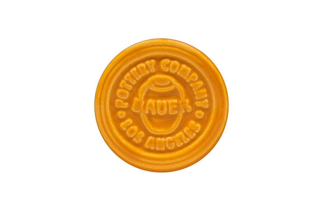 Orange ceramic stamp with Bauer Pottery Company