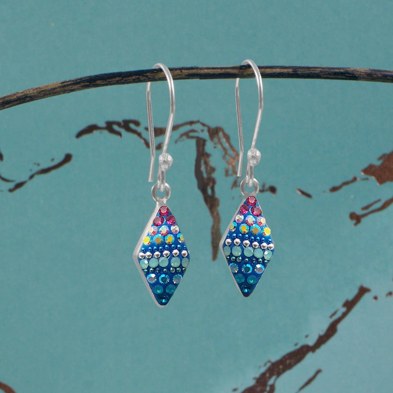 Close-up of Crystal Rhombus Earrings by Mosaico Jewels, highlighting the intricate rhombus shape and shimmering details.