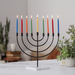 Black menorah with colorful candles 