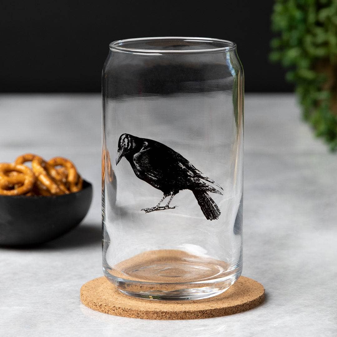 Enjoy a drink in style with the Crow Beer Can Glass - 16oz, Dishwasher Safe and Hand-Drawn, designed to add a macabre twist to your happy hour!
