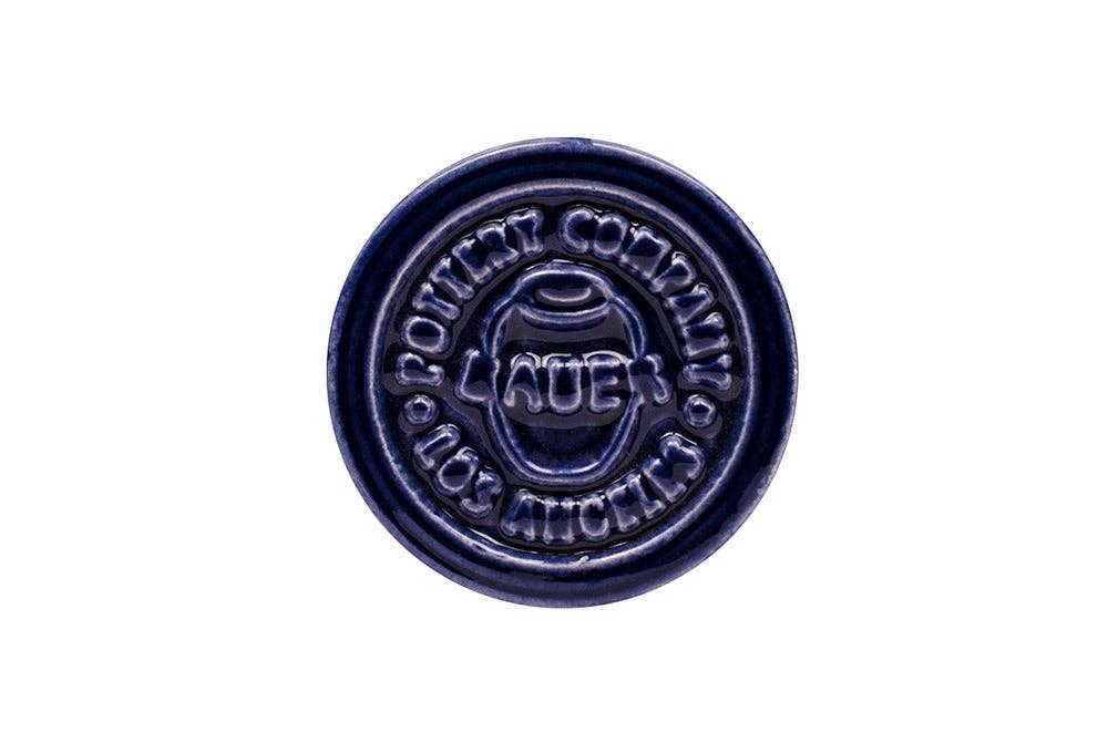 Navy blue ceramic stamp with Bauer Pottery Company