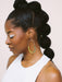 Close-up profile of a model wearing On the Move Macramé Earrings by Twenty Two West, featuring bold color block design, with hair styled in an elegant updo.