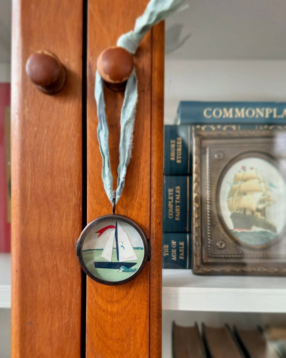 Vintage-style nautical boat art locket ornament.