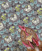 Close-up of a chicken artwork by Emily Uchytil, highlighting a vibrant farm animal and its unique patterns on a decorative backdrop.