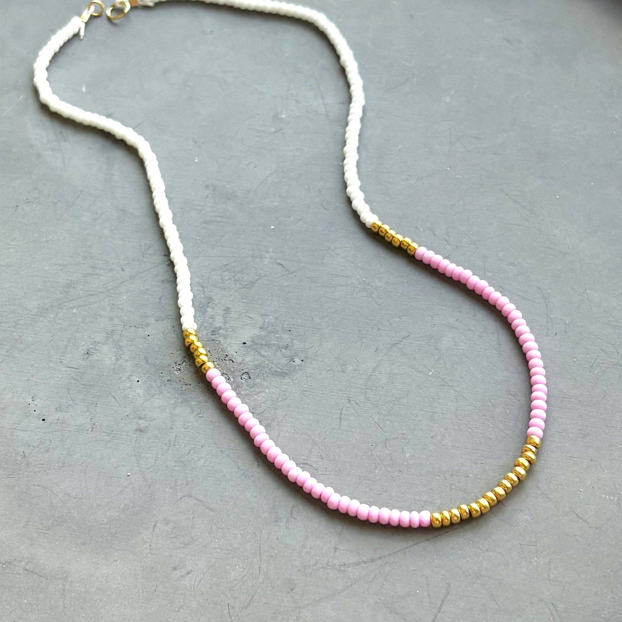 Lithe No. 2 Beaded Necklace by The Silver Wren with a delicate design of pink and white seed beads interspersed with gold filled accents, ideal for music festivals or beach days.