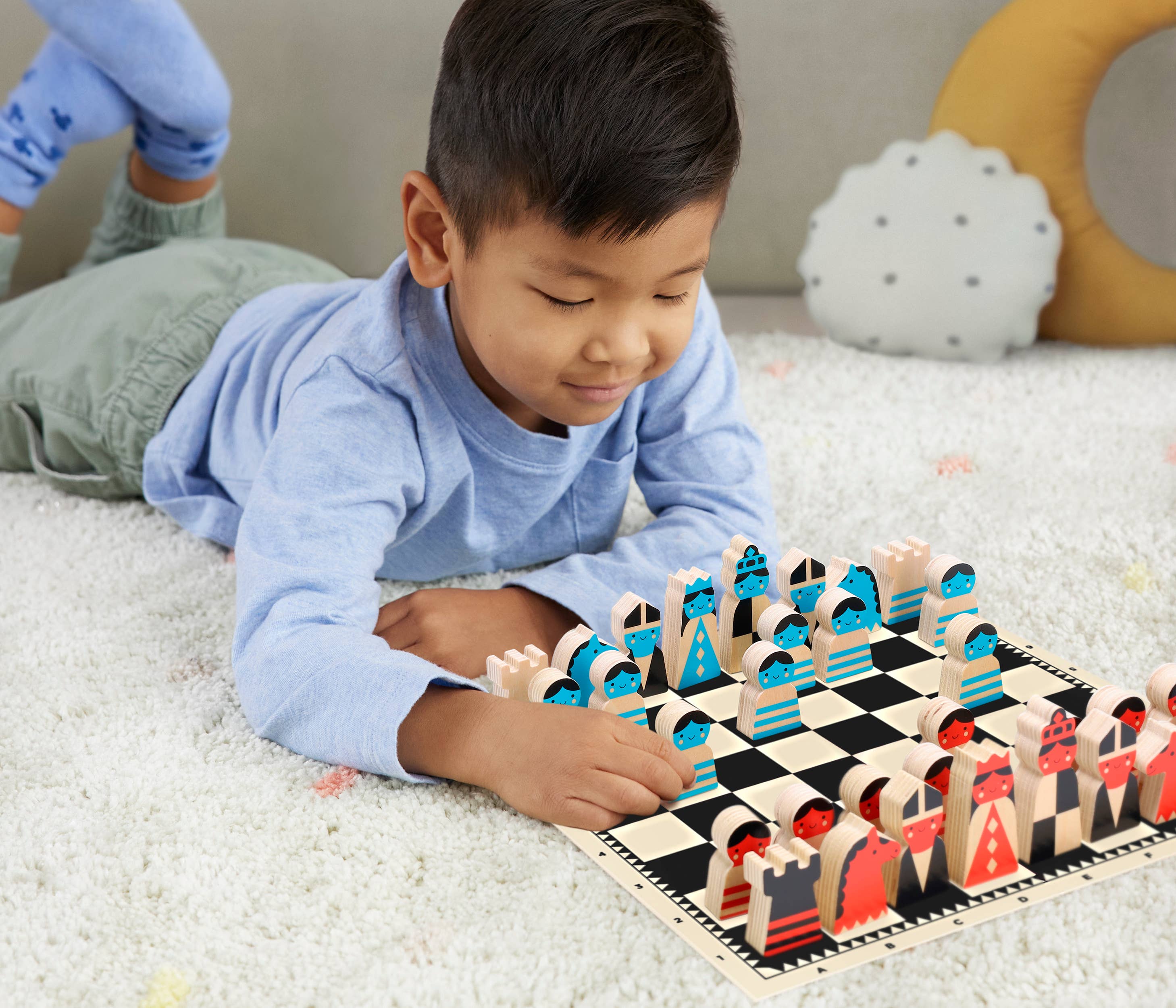 boy playing On the move wooden chess set