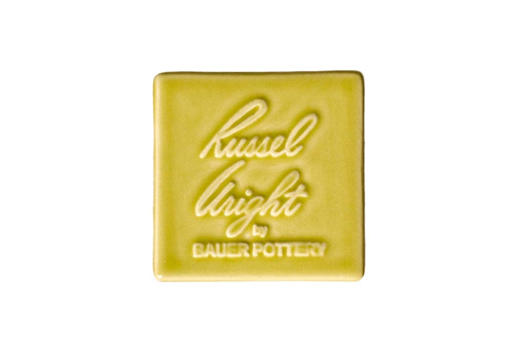 Yellow square tile with 'Russel Wright by Bauer Pottery' text on a white background