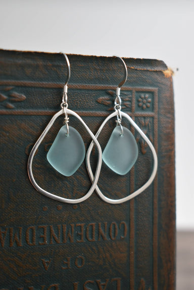 Close-up of Organic Eco Glass Earrings made from 100% recycled glass and .925 silver hooks, showcasing an eco-friendly accessory with a frosted sea glass finish.