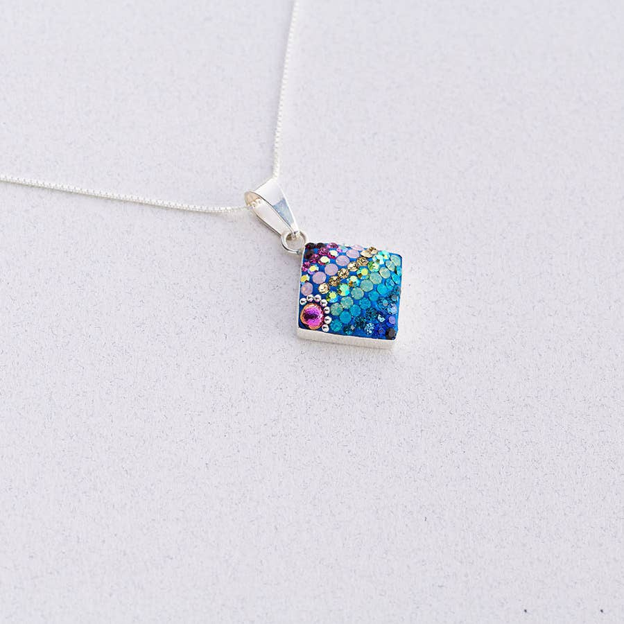 Delicate Diamond Pendant by Mosaico Jewels showcasing its intricate design and sparkling charm.