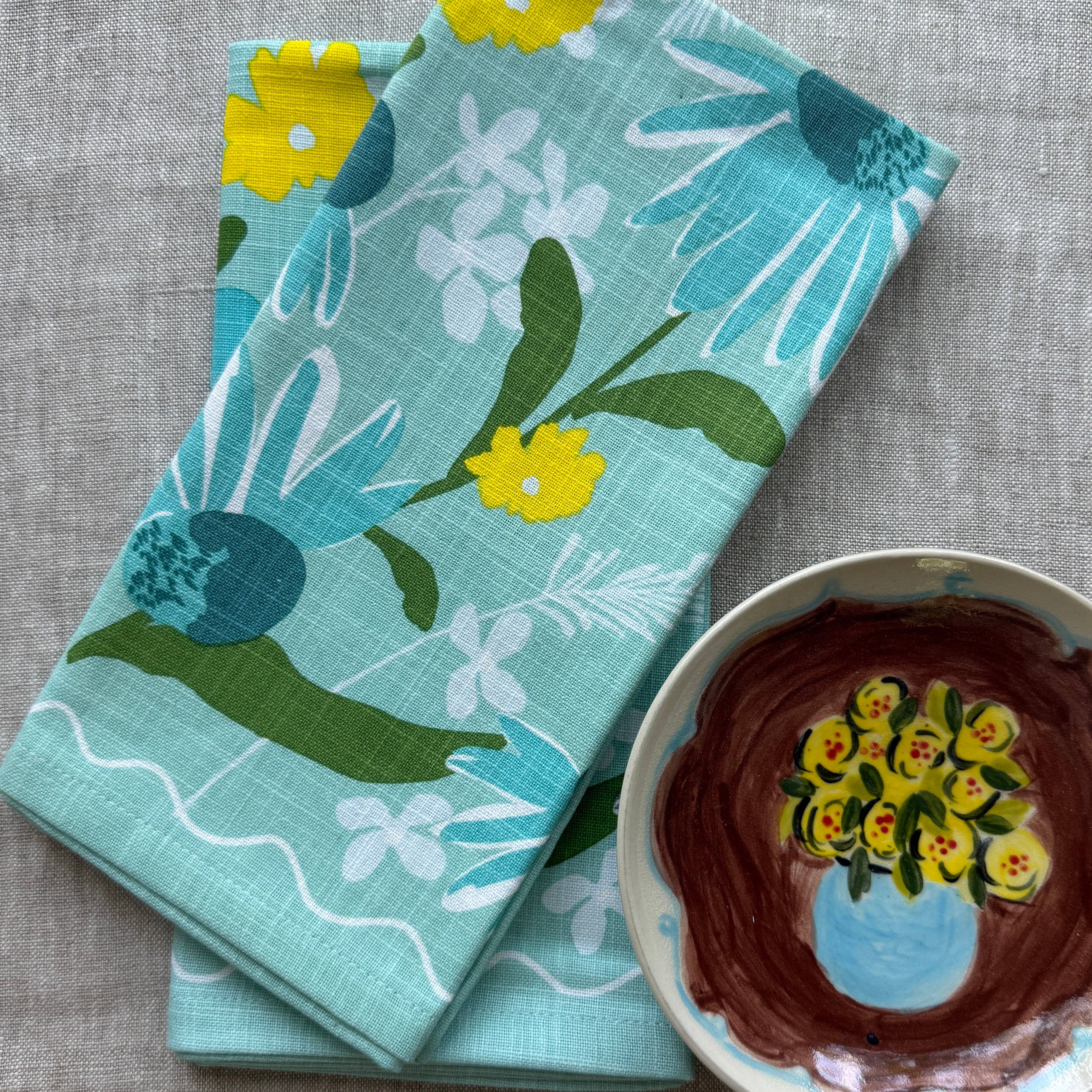 Moonlit Napkin Set arranged beautifully, highlighting the vibrant blue hues and delicate echinacea flowers, perfect for any occasion.