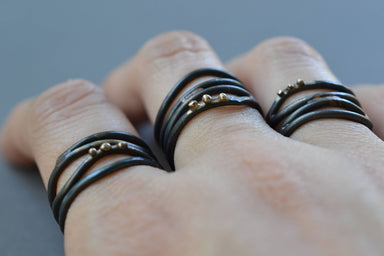 View the Linear Wrap Ring in all its glory: a beautiful blend of steel and recycled 10k gold, perfect for finger fashionistas!
