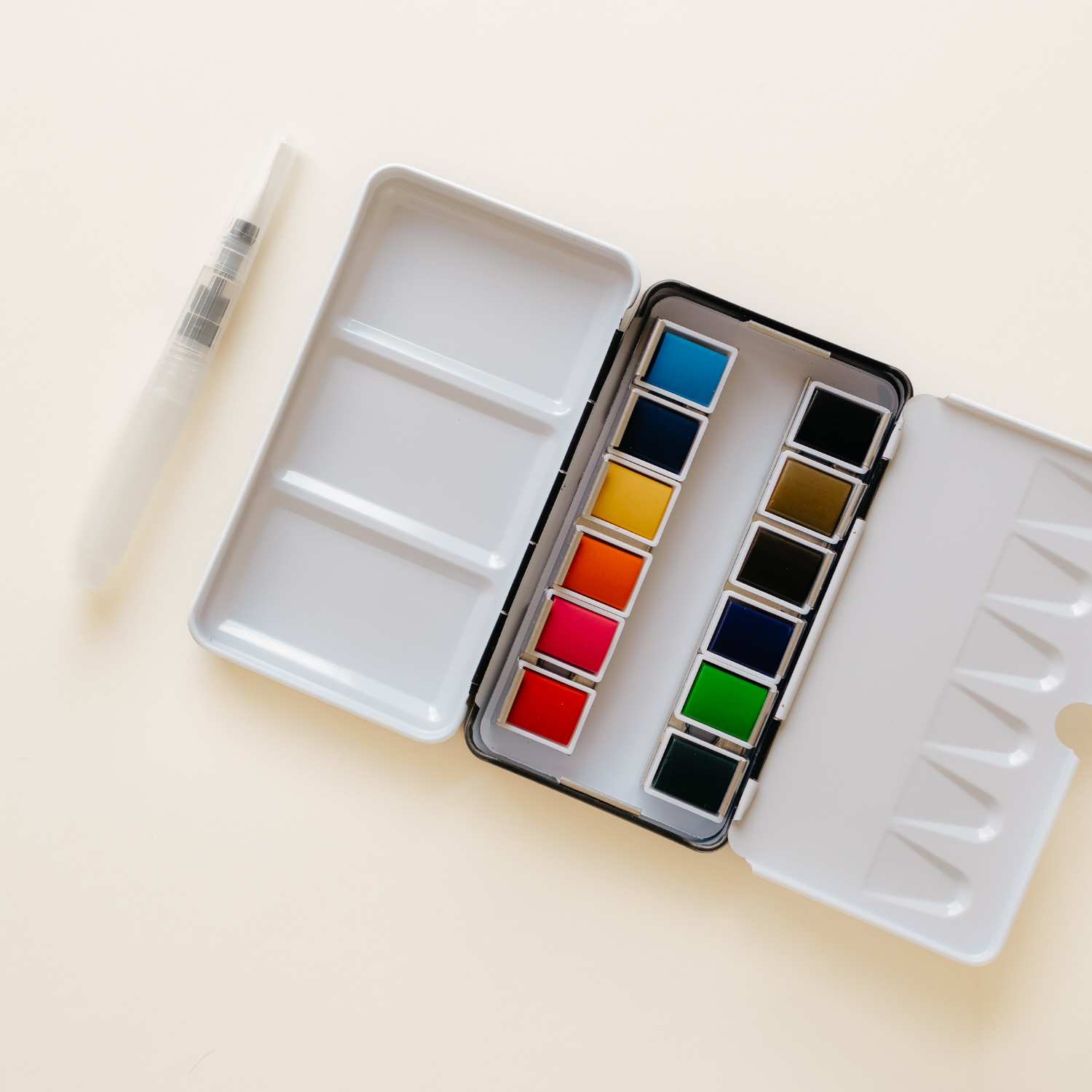 Compact 12 Color Mini-Travel Watercolor Paint Palette showing vibrant colors, perfect for travel and workshops.