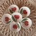 Handcrafted Red Poppy Tea Rest by Tough Kitty Designs featuring a circular dish with red poppy flower design, perfect for holding trinkets, tea bags, or spices. Each unique mini dish measures 3 inches in diameter.