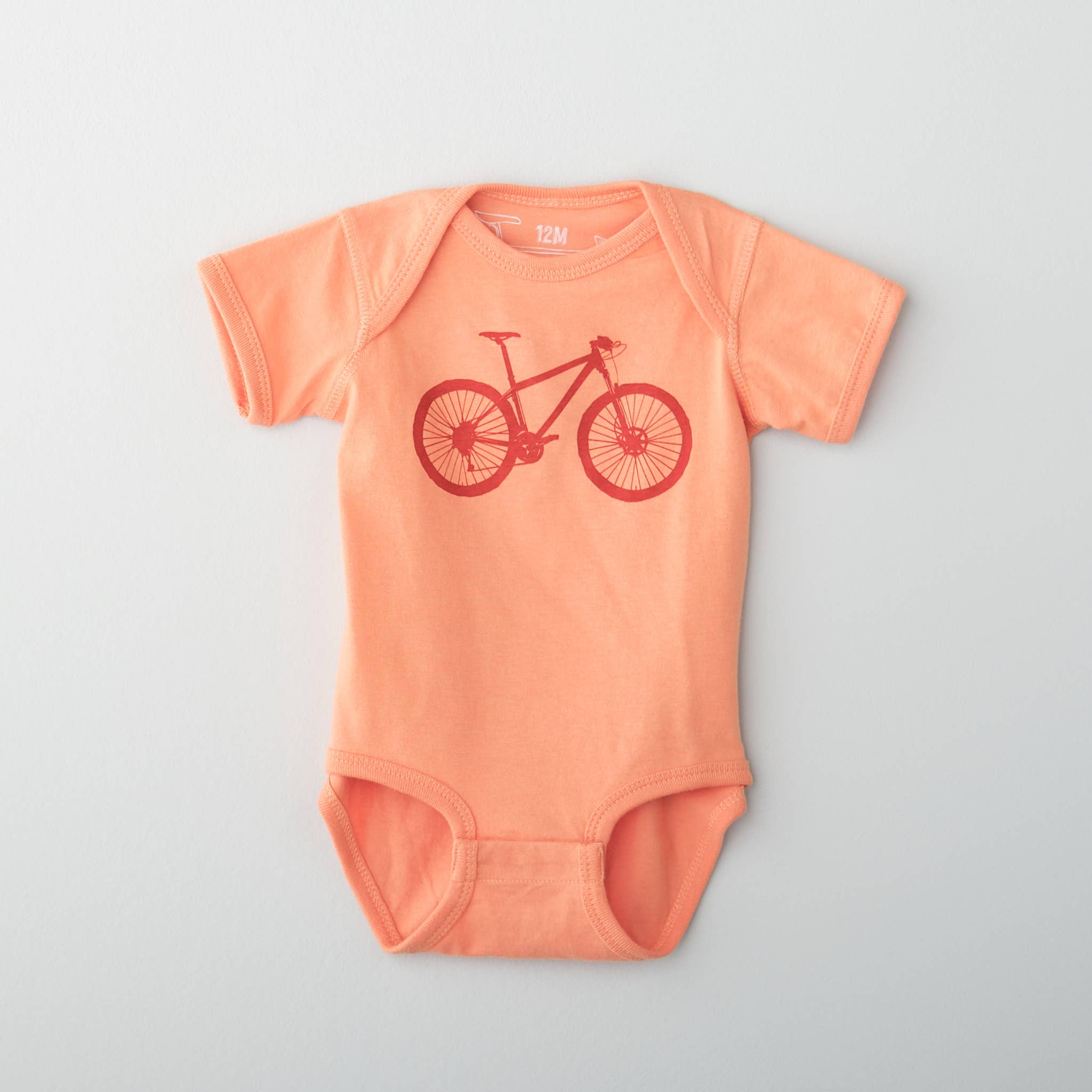 orange onesie for baby with bike