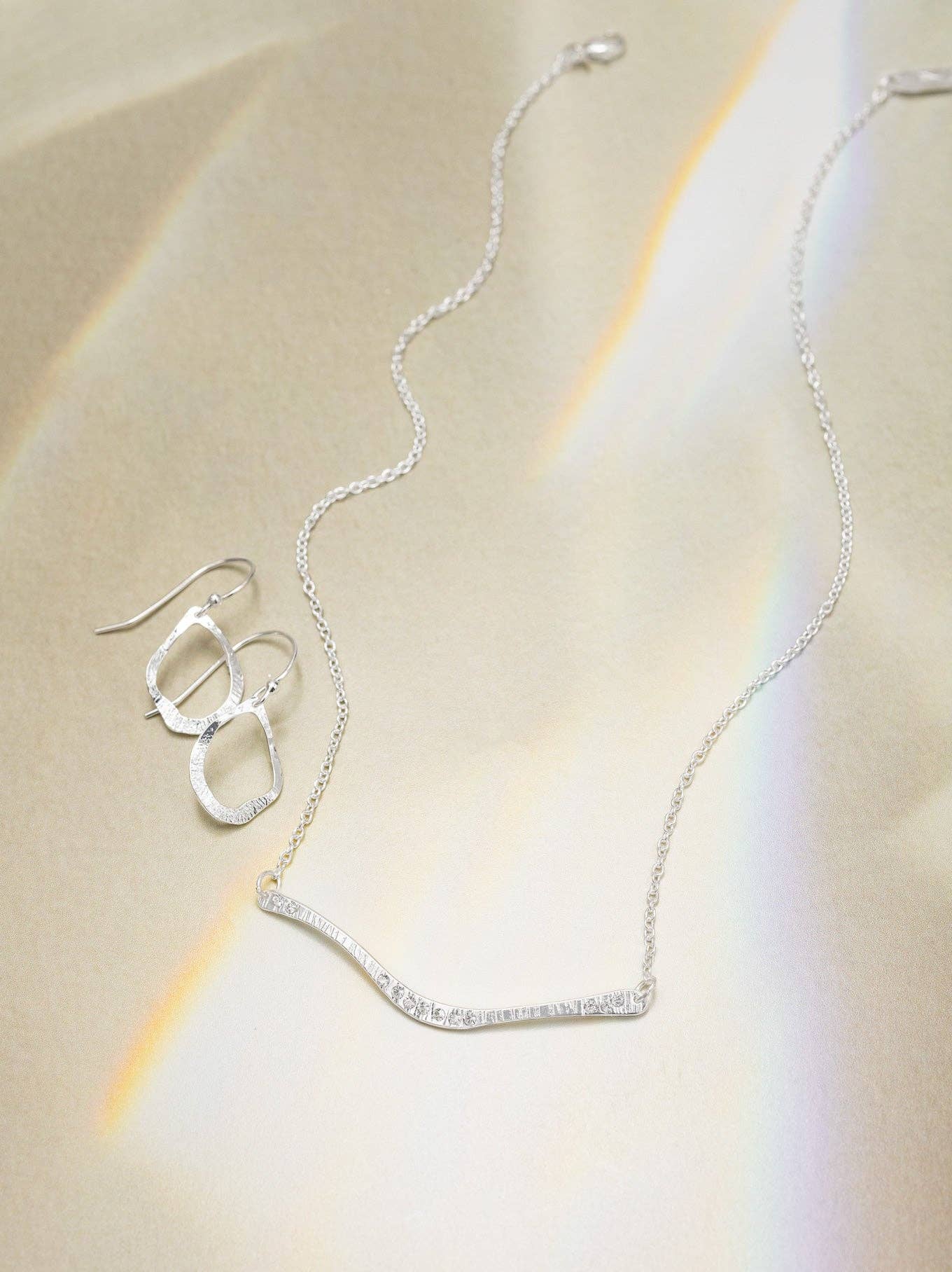 Close-up of the Nina Earrings showcasing the hand-hammered finish—talk about lustrous! These 18K gold-plated beauties are not just accessories, they're a statement of your fabulous style.
