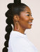 Profile view of a model laughing while wearing On the Move Macramé Earrings by Twenty Two West, her hair styled in a chic ponytail accentuating the earrings.